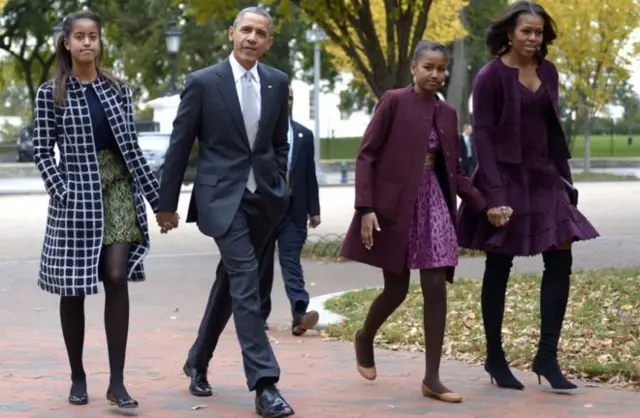 US President Barack Obama walks with his wife Michelle Obama (R) and two daughters Malia Obama (L) and Sasha Obama (2R) through Lafayette Park to St John's Church to attend service October 27, 2013 in Washington, DC.