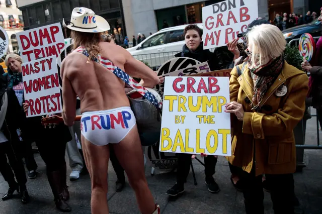 Robert Burck, known as the "Naked Cowboy", confronts Trump supporters in New York, 8 November