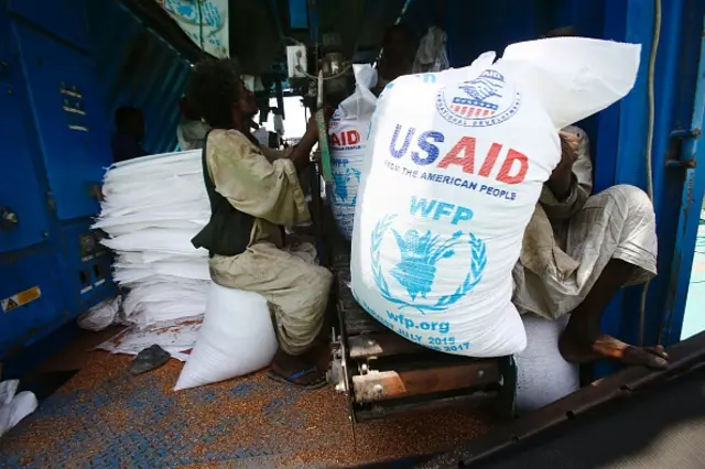 Sudanese dockers unload a US aid shipment organised by the US Agency for International Development and the World Food Programme at Port Sudan on the Red Sea coast, on May 5, 2016.