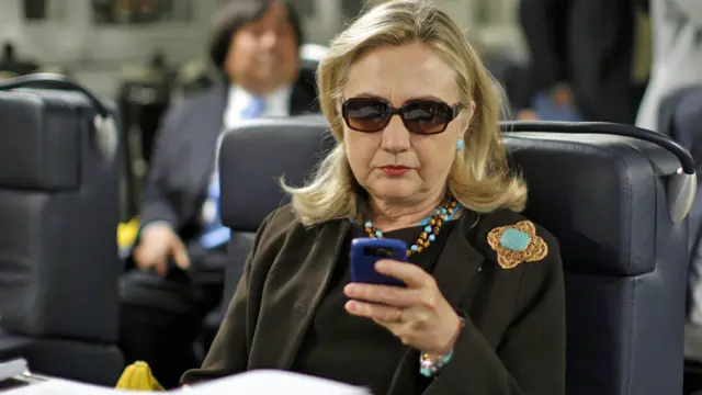 Then-Secretary of State Hillary Rodham Clinton checks her Blackberry - 18 October 2011