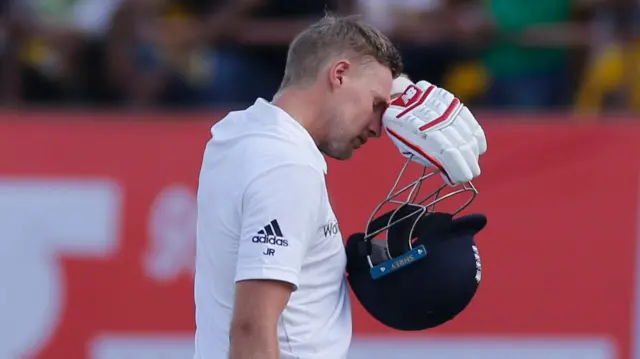 Joe Root walks off the field