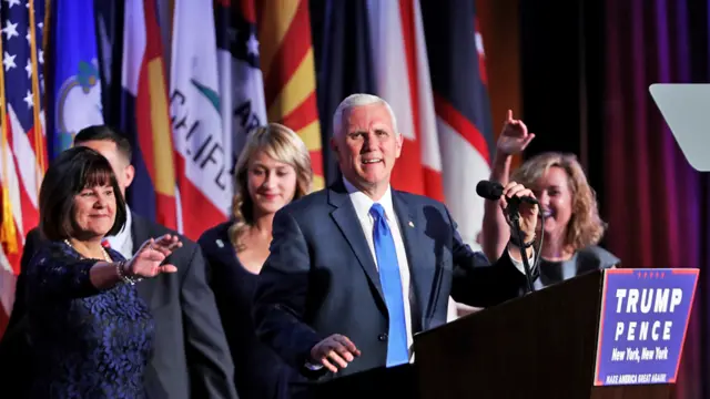 Vice president-elect Mike Pence (C) speaks to supporters at Republican president-elect Donald Trump"s election night event at the New York Hilton Midtown in the early morning hours of November 9, 2016