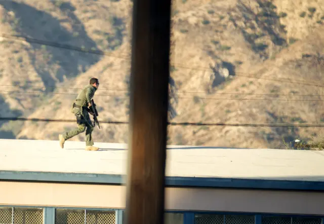 SWAT team snipers move into position near the polling location