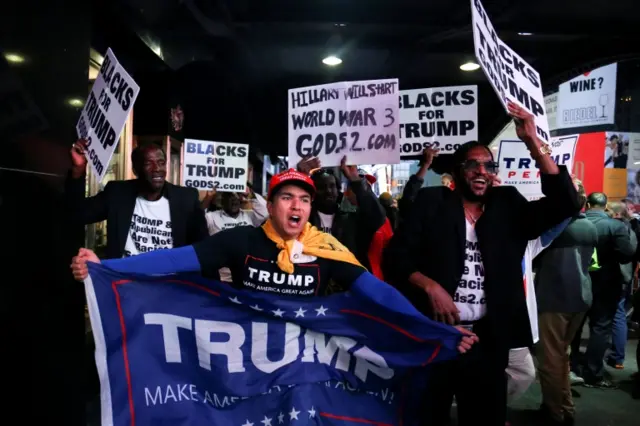 Supporters of U.S. President-elect Donald Trump rally through Times Square, Manhattan, New York