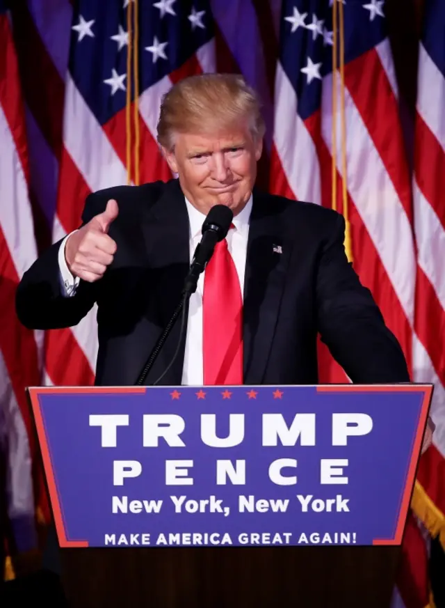 Republican president-elect Donald Trump gives a thumbs up to the crowd during his acceptance speech at his election night event at the New York Hilton Midtown in the early morning hours of November 9, 2016 in New York City.