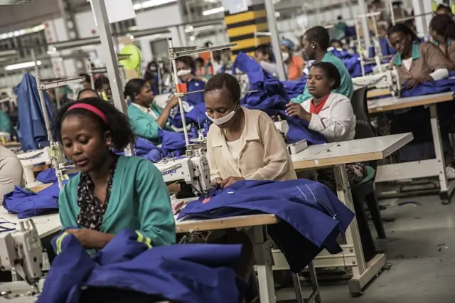 Workers of a foreign-owned textile factory sew on machines during their shift on September 1, 2015 in the factory on the outskirts of Matsapha, Swaziland.