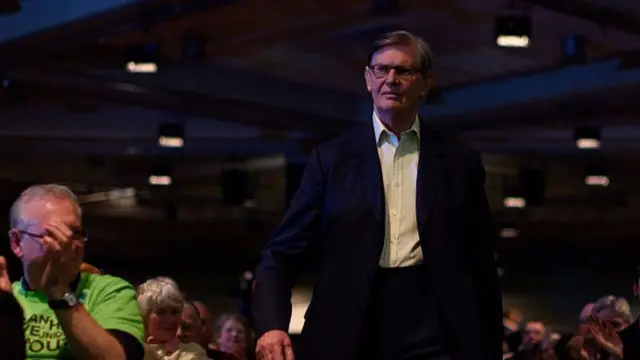 Sir Bill Cash walking through a crowd