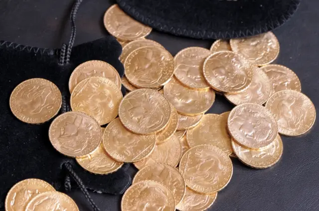 Gold coins on a table in a Paris broker's shop