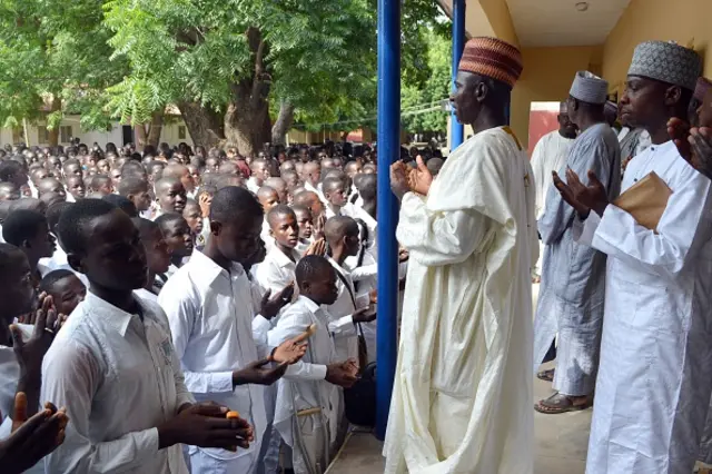 Muslim teachers pray with students of government college during an assembly following the re-opening of public schools in Maiduguri, northeast Nigeria, on October 10, 2016. Students from public school in northeast Nigeria, from where more than