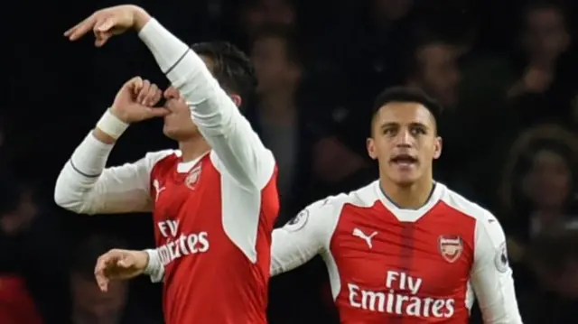 Mesut Ozil celebrates scoring their second goal with Alexis Sanchez