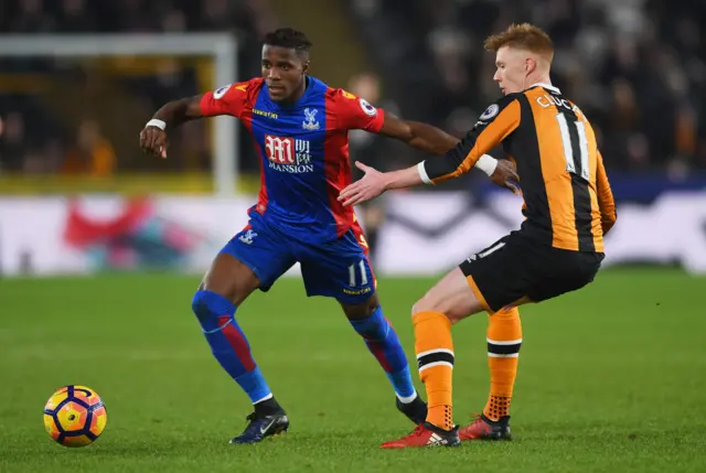 Wilfried Zaha vies for the ball