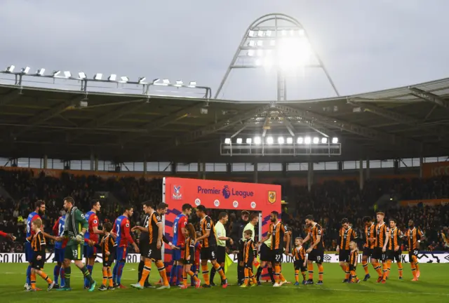 Hull City and Crystal Palace players walk onto the pitch