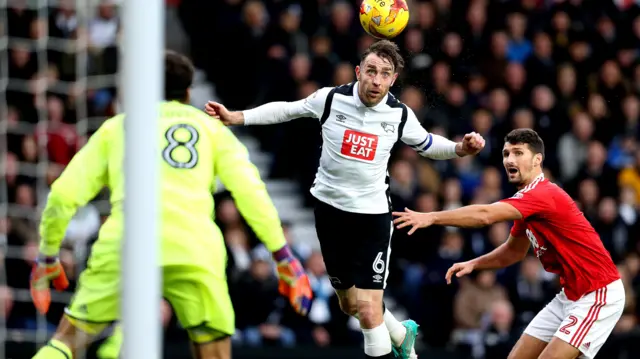 Richard Keogh of Derby County heads the ball towards goal