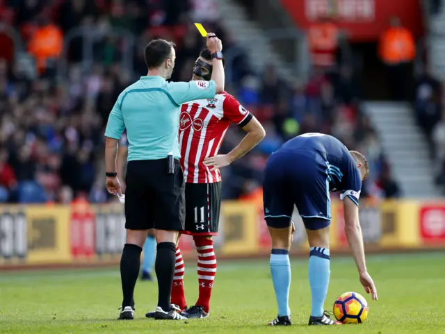 Dusan Tadic is shown a yellow card