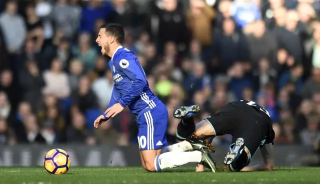 Gareth McAuley fouls Eden Hazard