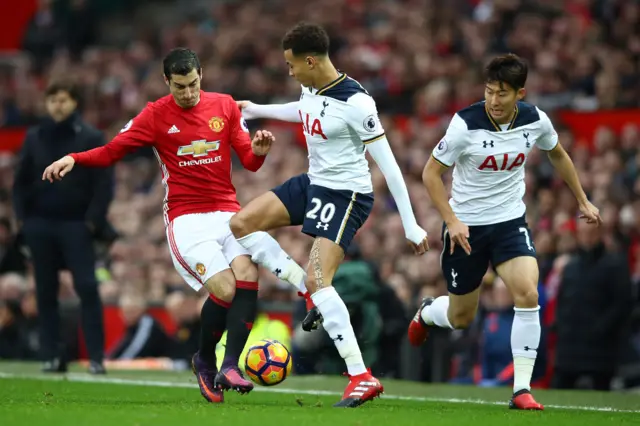 Henrikh Mkhitaryan of Manchester United and Dele Alli of Tottenham Hotspur compete for the ball