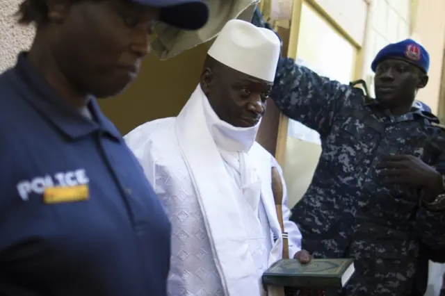 Incumbent Gambian president Yahya Jammeh (C) leaves the polling booth after casting his marble for presidential election in a polling station, in Banjul on December 01, 2016.