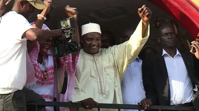 This video grab taken from footage shot by AFPTV shows The Gambia's President-elect Adama Barrow gesturing to the crowd following his victory in the polls in Kololi on December 2, 2016.