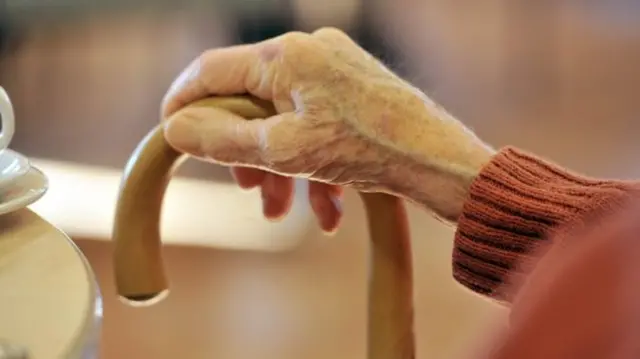 Generic pictures of elderly hand on walking stick