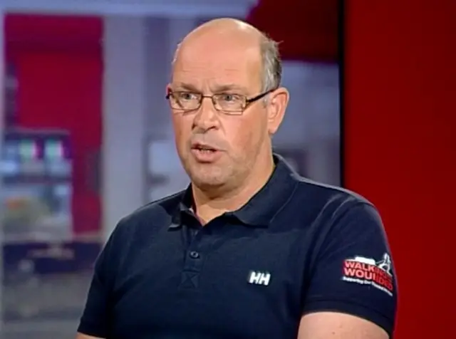 Ed Parker, in short sleeve blue top, wearing glasses, in BBC Look East's studio