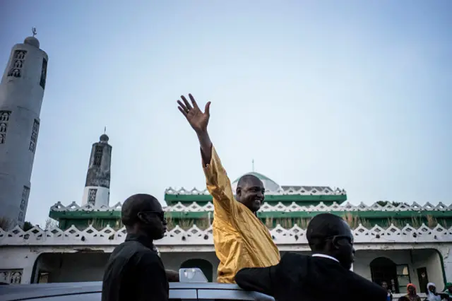 The flag-bearer of the coalition of the seven opposition political parties in Gambia Adama Barrow (C), greets supporters at a gathering in Jambur on November 26, 2016