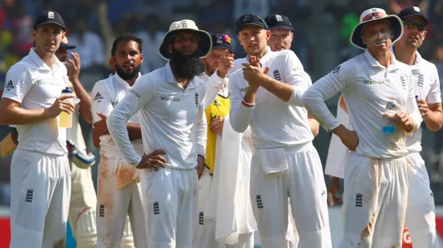 England's players wait for a review decision