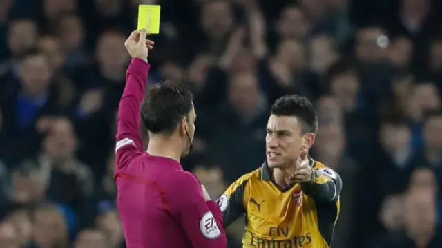 Laurent Koscielny is shown a yellow card