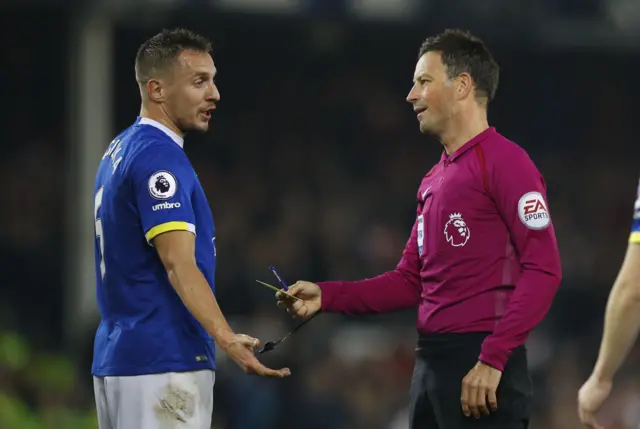 Phil Jagielka reacts after being shown a yellow card