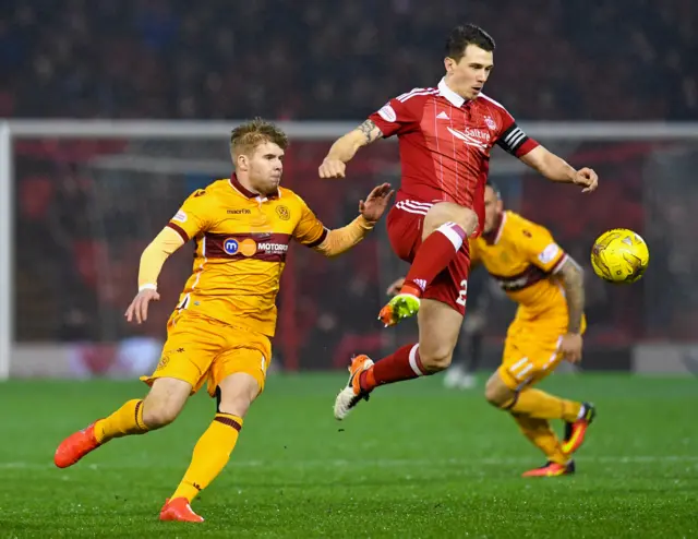 Aberdeen's Ryan Jack (right) controls the ball under pressure from Motherwell's Chris Cadden