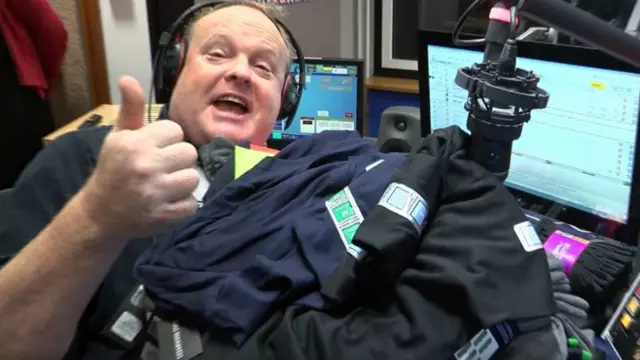 Breakfast presenter Mark Murphy under a pile of socks