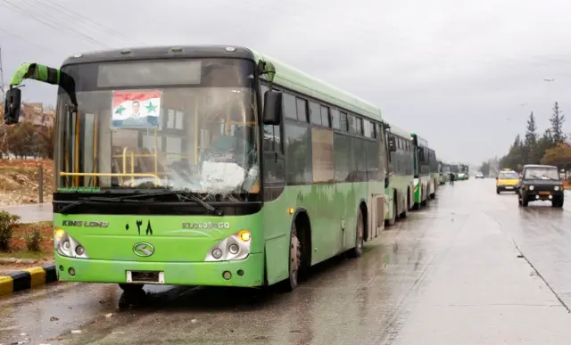 Buses wait to evacuate people from rebel-held Aleppo (14 December 2016)