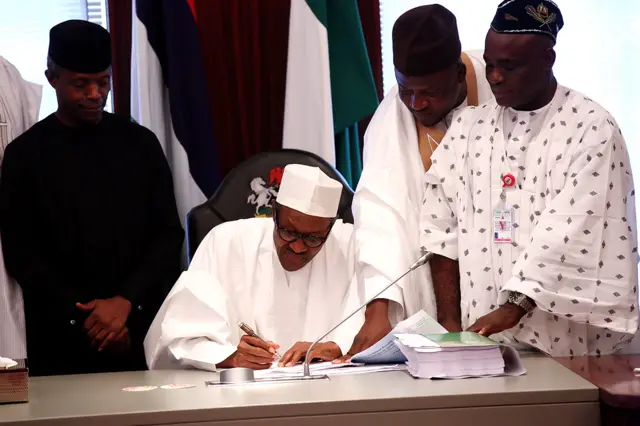 President of Nigeria Muhammadu Buhari signing his first budget in 2015