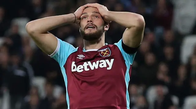 Andy Carroll reacts after missing a chance