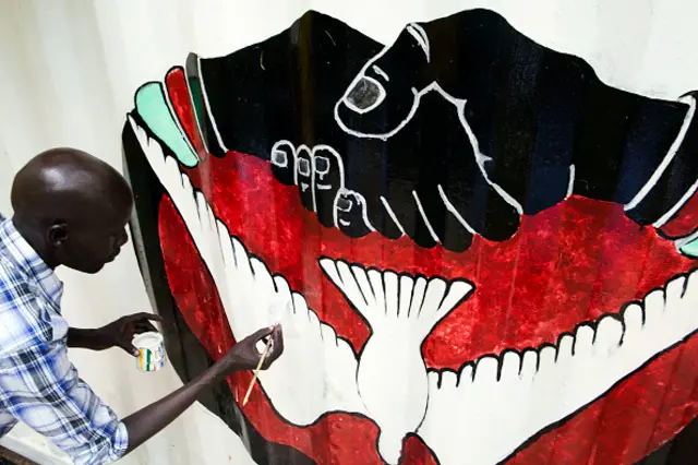 A member of the new activist movement #AnaTaban, paints a new mural at the Aggrey Jaden cultural centre in Juba, South Sudan, on September 18, 2016.