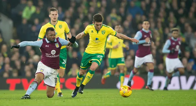 Norwich's Ivo Pinto battles for the ball with Villa's Jordan Ayew