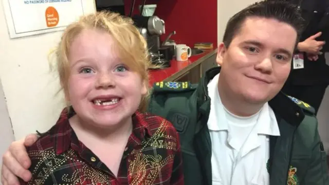 Lilly-Mae (left) and East Midlands Ambulance Service staff member