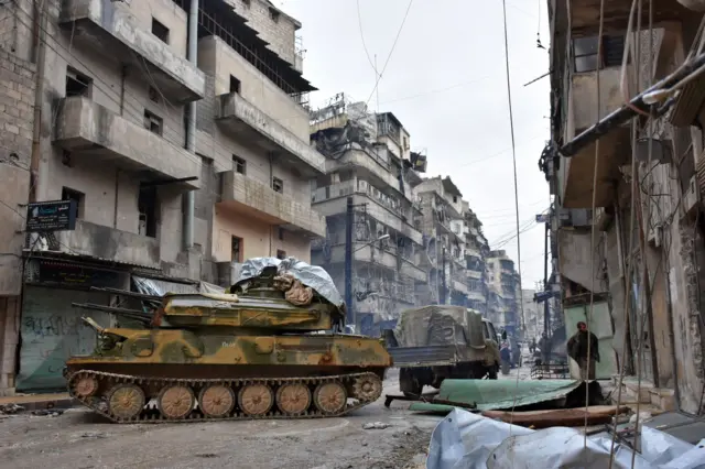 Syrian pro-government forces advance in the Jisr al-Haj neighbourhood during the ongoing military operation to retake remaining rebel-held areas in the northern embattled city of Aleppo on December 14, 2016. Shelling and air strikes sent terrified residents running through the streets of Aleppo as a deal to evacuate rebel districts of the city was in danger of falling apart.