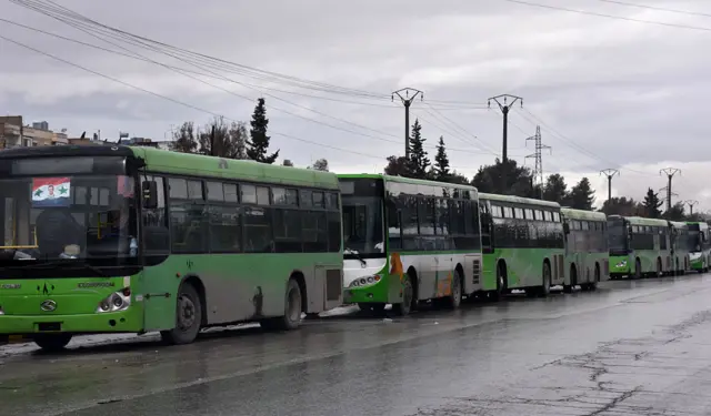 Buses which will be used to evacuate civilians leaving from rebel-held areas of Aleppo are seen waiting on December 14, 2016.