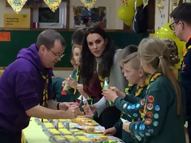 The Duchess of Cambridge with young Cubs icing cupcakes