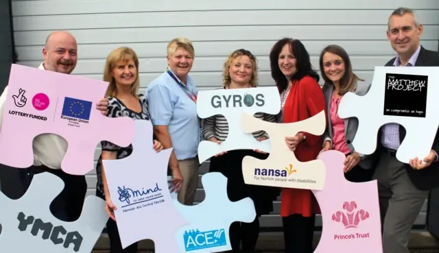 Representatives of the seven charities holding banners for their organisations