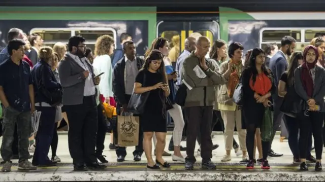 Commuters waiting at a train station