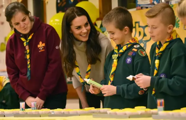 The Duchess of Cambridge, in yellow Cub scarf, with youngsters