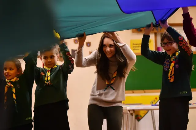 The Duchess of Cambridge with a multi-coloured parachute, in a game