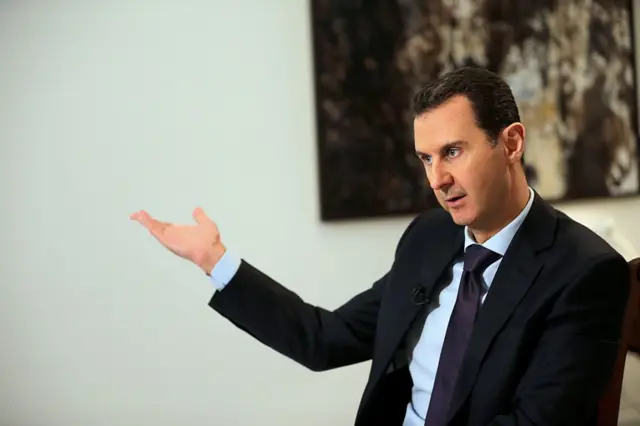 Syrian President Bashar al-Assad gestures during an interview with AFP in the capital Damascus on February 11, 2016.