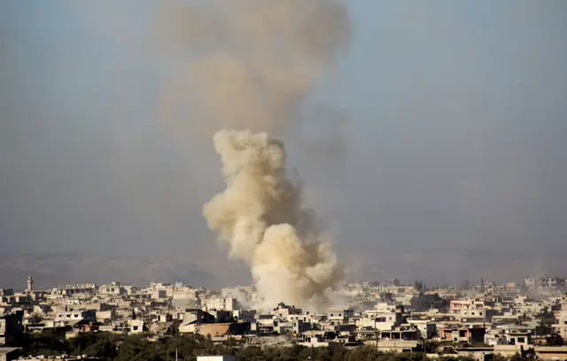 A picture taken from a rebel-held area shows smoke billowing from buidings in the pro-regime Shiite town of Foua, in northwestern Idlib province, on December 6, 2016 following a reported rebel shelling.