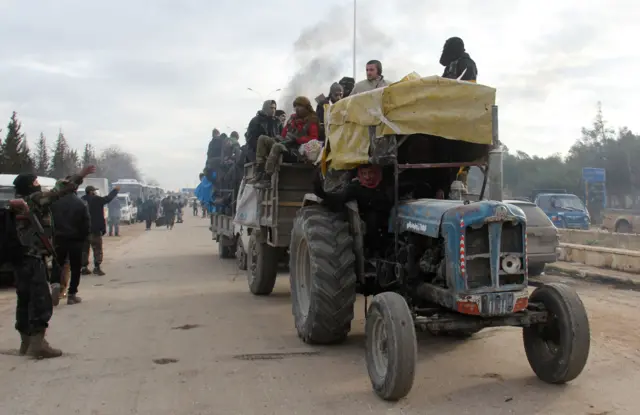 A tractor carrying people from East Aleppo arrives in rebel-held Khan al-Assal