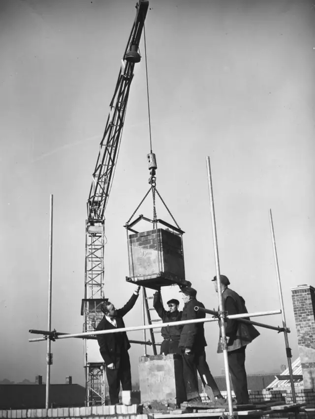 Ernest Marples was captured on camera overseeing the laying of a chimney stack at North Park Avenue Estate, Norwich