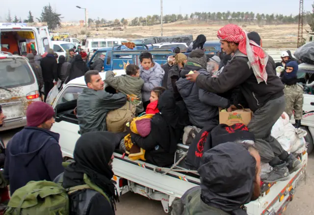 Syrian rebel fighters and civilians who were evacuated from rebel-held neighbourhoods in the embattled city of Aleppo arrive in the opposition-controlled Khan al-Aassal region, west of the embattled city, on December 16, 2016.