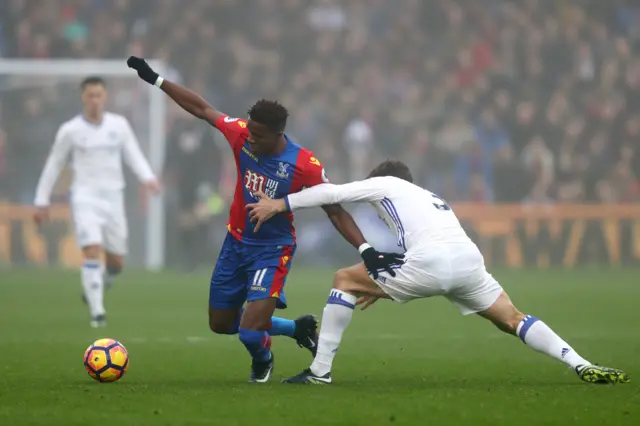 Zaha and Alonso compete for the ball