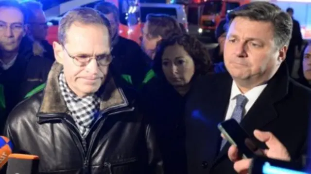 Berlin Mayor Michael Mueller (left) speaks to the media at the scene of the incident